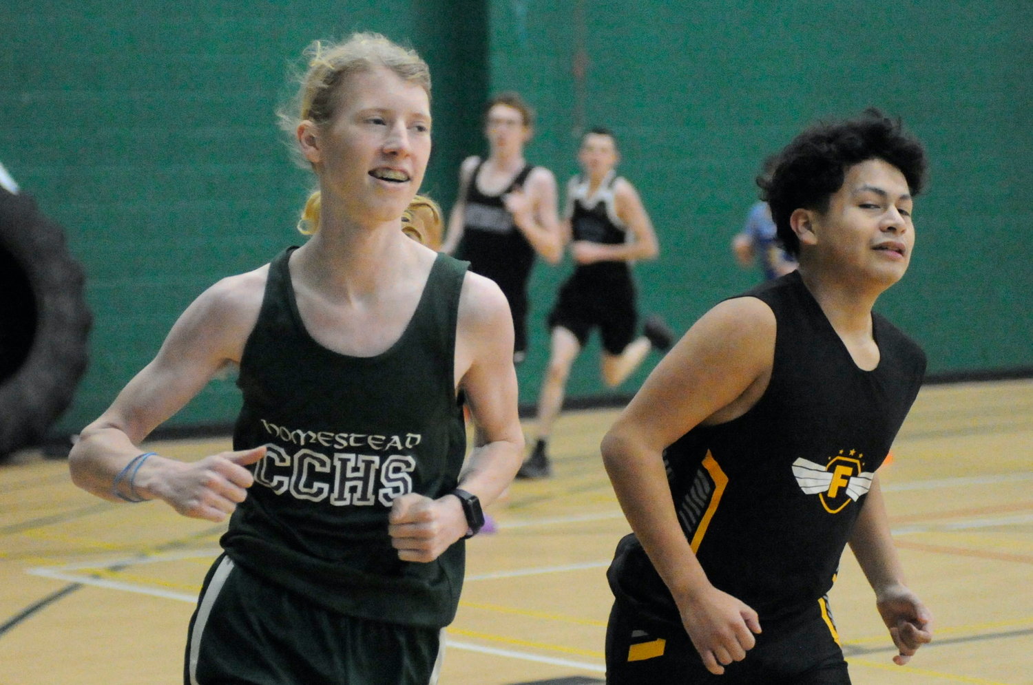 Sprint to the finish. Bryce Shannon is pictured on SUNY Sullivan’s indoor track with a long-distance runner from Fallsburg.